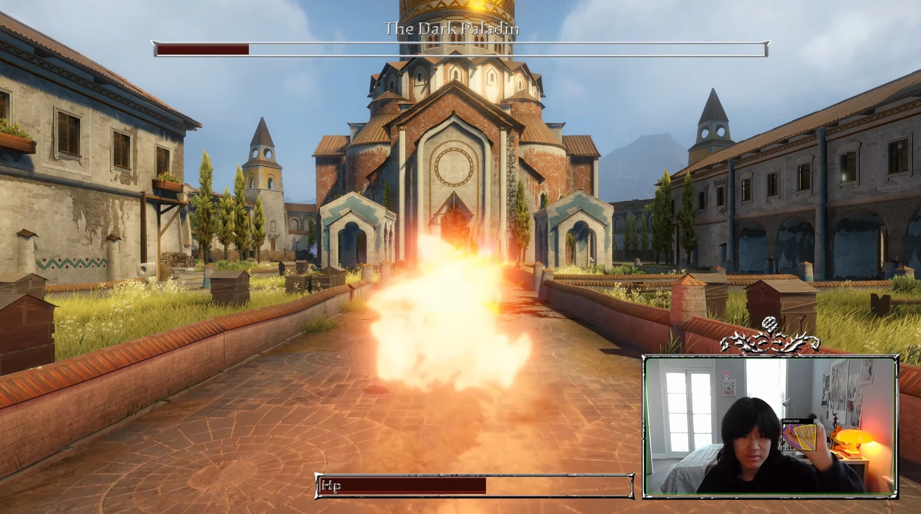 First-person fire spell cast in the town square with hand-tracking webcam overlay